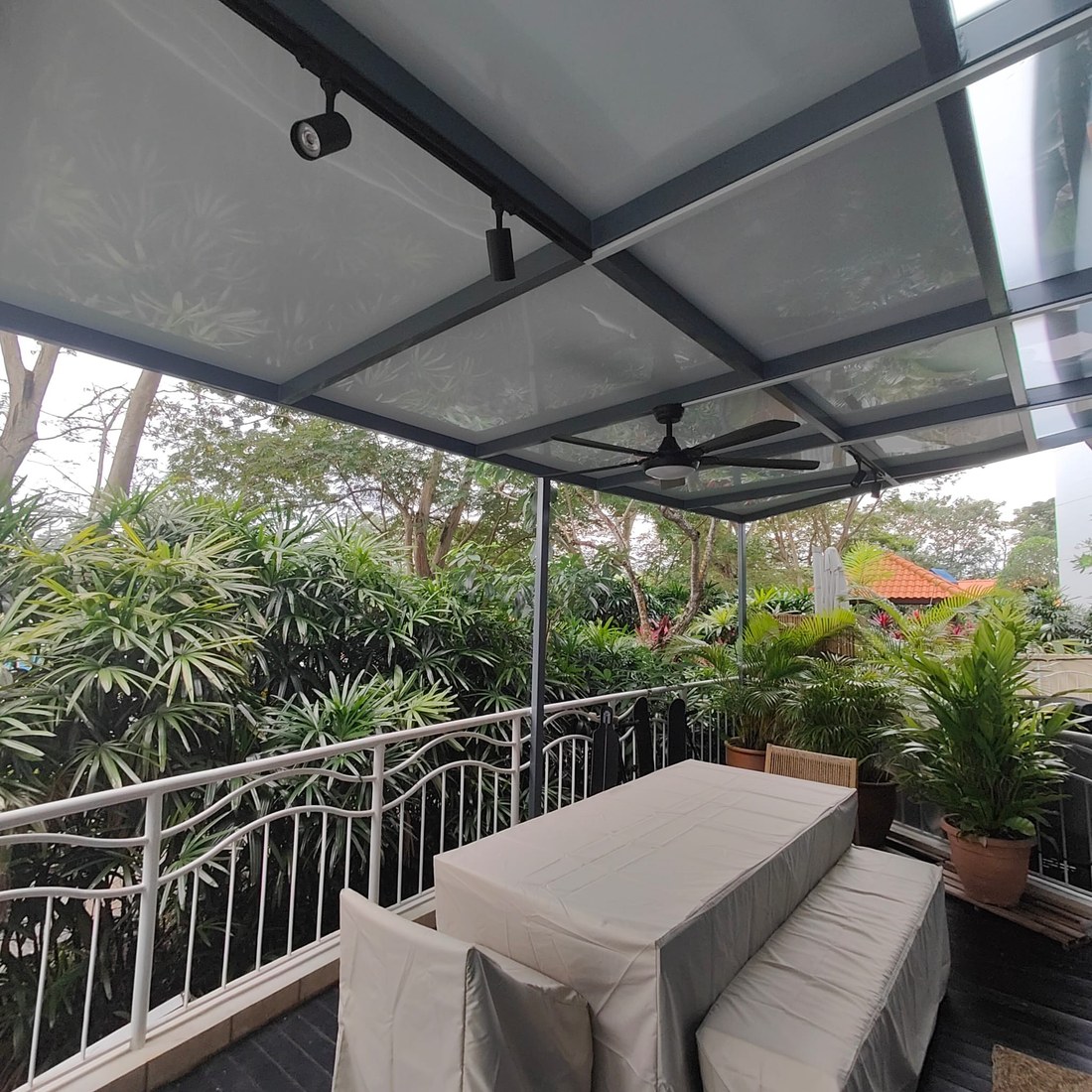 Glass pergola over an outdoor seating area
